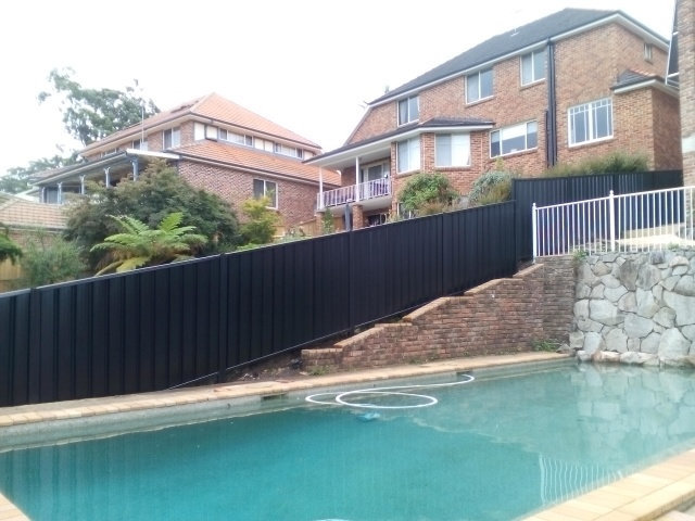 Colorbond fence extension beside a Sydney pool